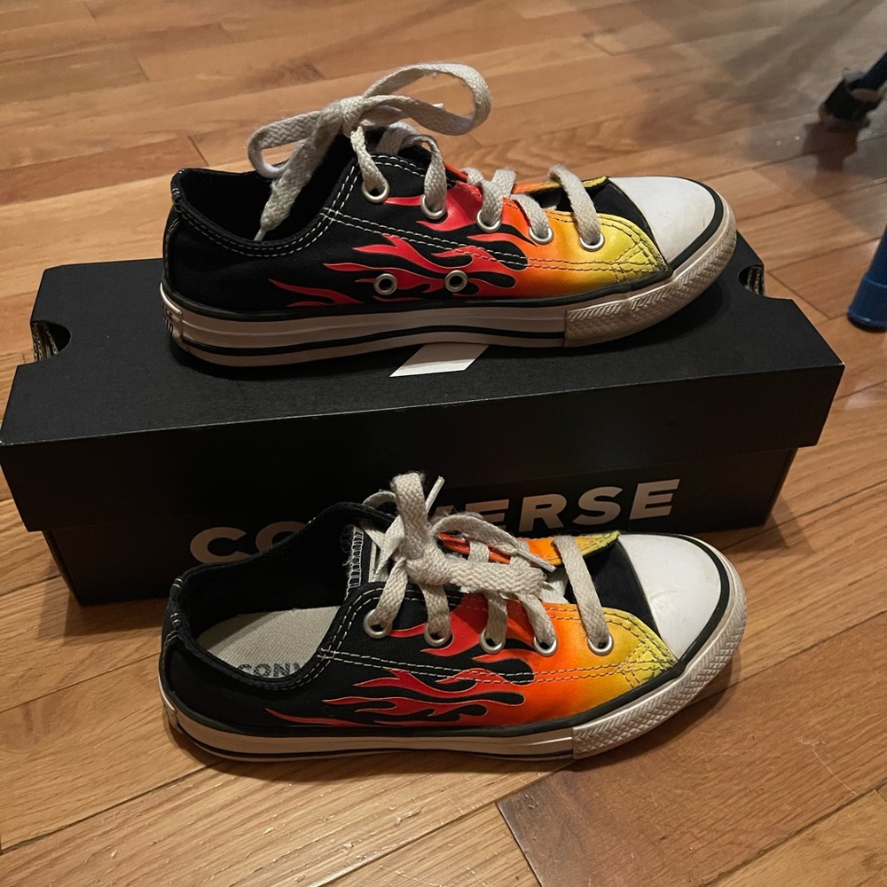 Pair of gently used converse all star shoes size 1 kids. Bright flames on sides